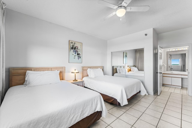 bedroom with light tile patterned flooring, sink, and ceiling fan