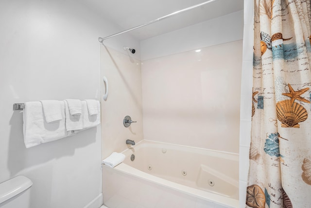 bathroom with shower / tub combo with curtain and toilet