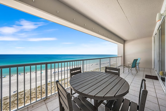 balcony with a beach view and a water view