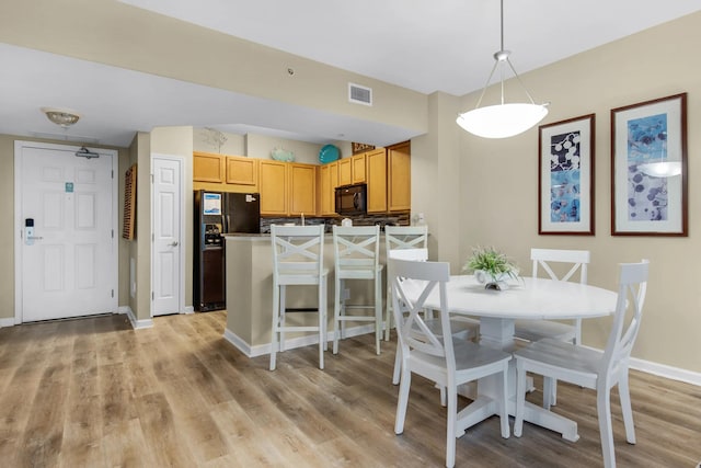 dining room with light hardwood / wood-style floors