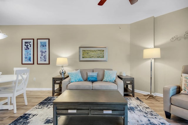 living room with hardwood / wood-style floors and ceiling fan