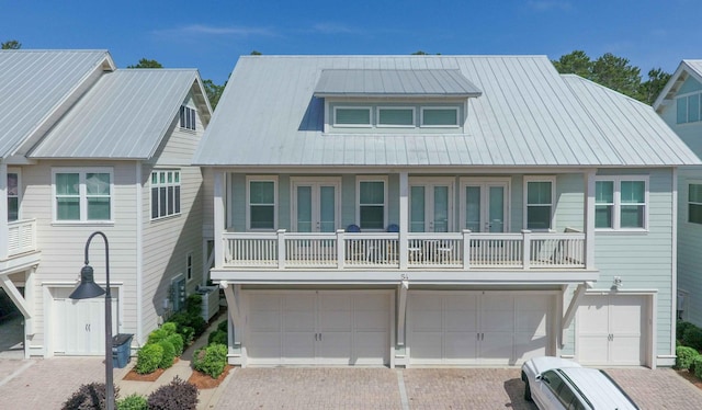 view of front facade with a balcony and a garage