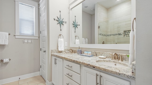 bathroom featuring dual sinks, a shower with shower door, oversized vanity, and tile flooring