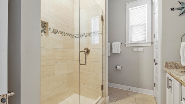 bathroom featuring vanity, an enclosed shower, and tile floors