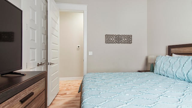 bedroom featuring light hardwood / wood-style floors and a closet