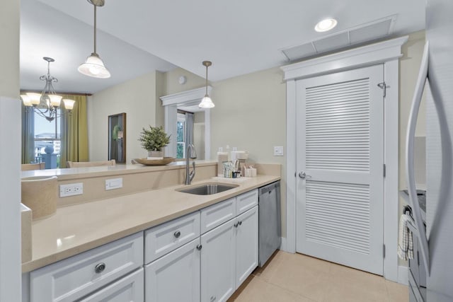 kitchen with white fridge with ice dispenser, decorative light fixtures, white cabinetry, light tile floors, and sink