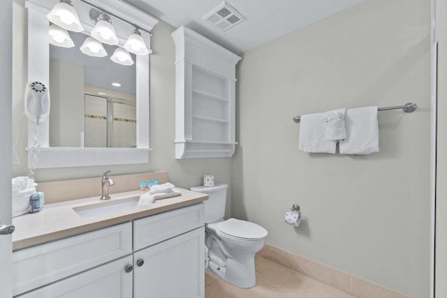 bathroom featuring vanity, toilet, and tile flooring