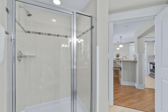 bathroom with wood-type flooring and walk in shower