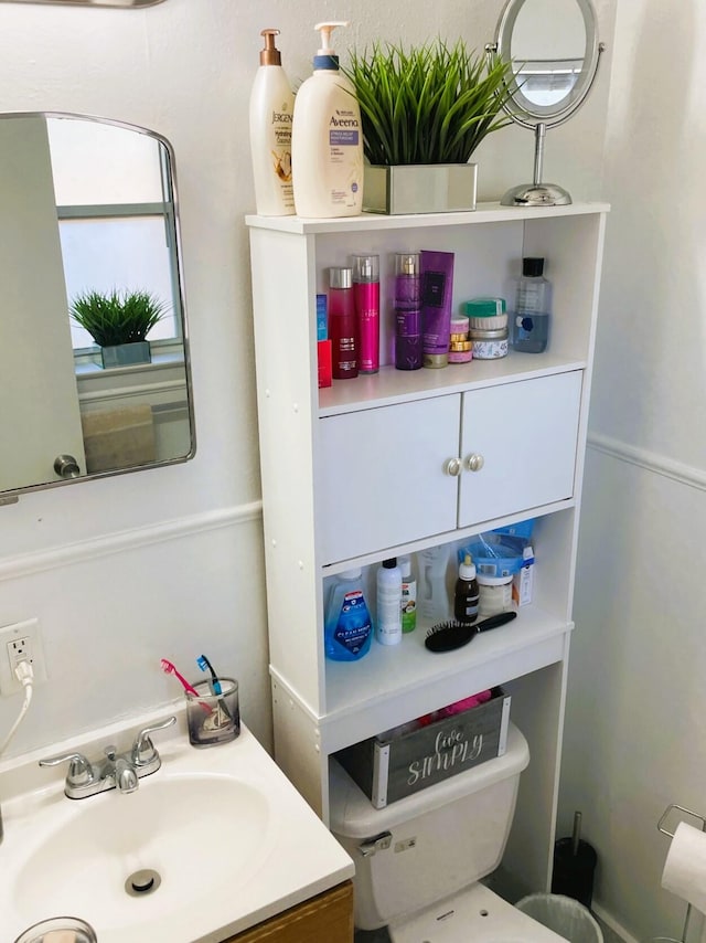 bathroom featuring vanity and toilet