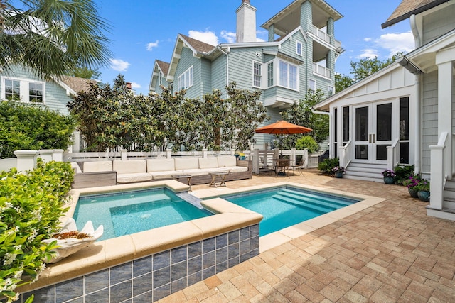 view of swimming pool with an in ground hot tub and a patio