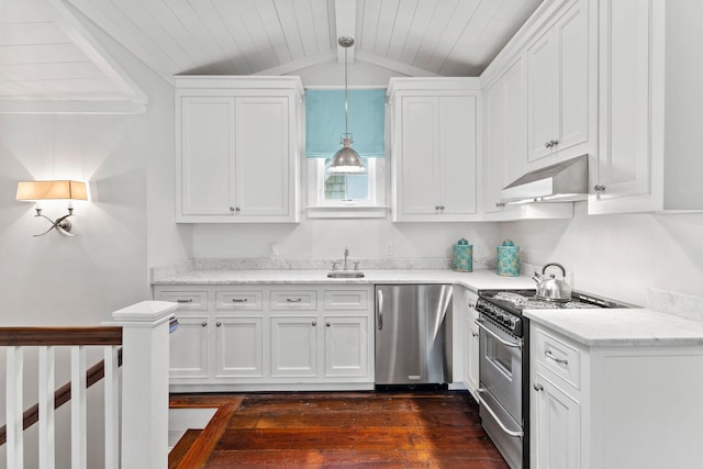 kitchen featuring pendant lighting, dark hardwood / wood-style floors, wall chimney range hood, stainless steel gas stove, and dishwasher