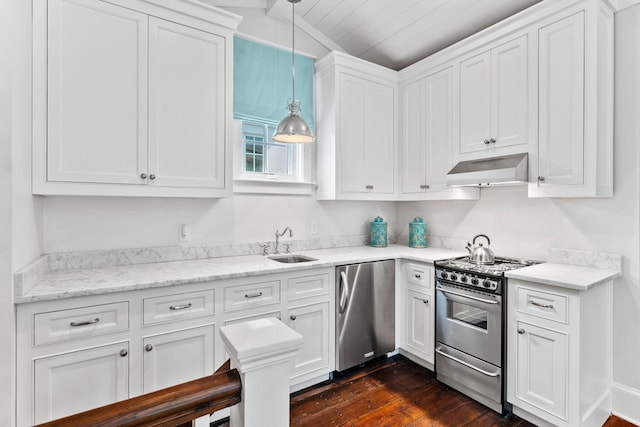 kitchen with decorative light fixtures, stainless steel appliances, dark hardwood / wood-style floors, white cabinets, and sink