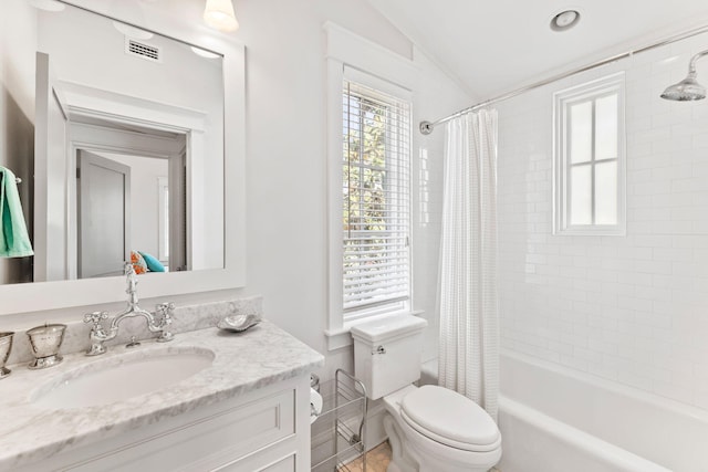 full bathroom with vaulted ceiling, vanity with extensive cabinet space, toilet, and shower / bathtub combination with curtain