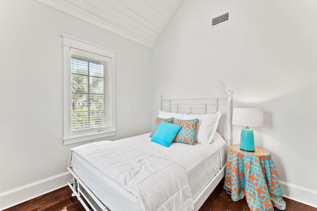 bedroom with wood-type flooring and vaulted ceiling