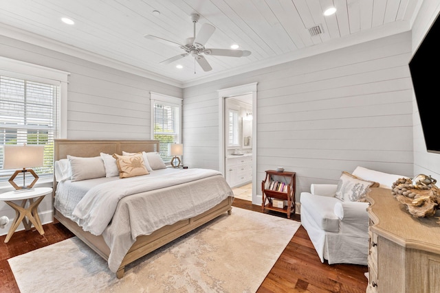 bedroom featuring ceiling fan, connected bathroom, dark wood-type flooring, ornamental molding, and wooden ceiling