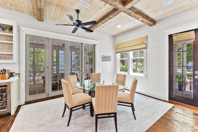 dining room with beamed ceiling, french doors, wood ceiling, hardwood / wood-style flooring, and ceiling fan