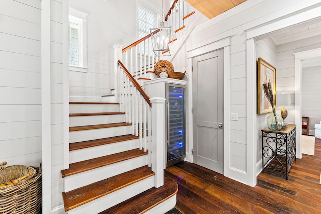 stairway with wood ceiling and dark hardwood / wood-style floors