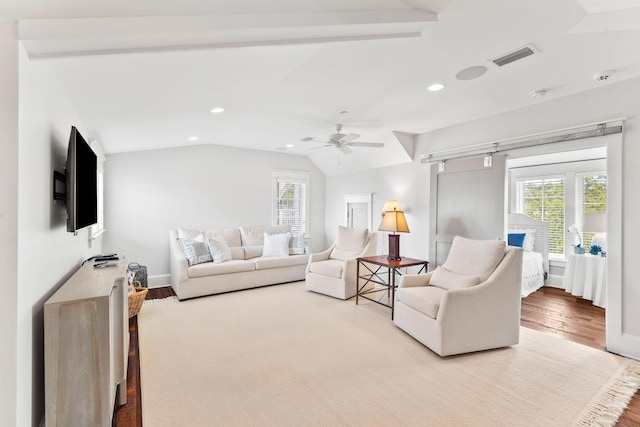 living room with wood-type flooring, ceiling fan, and lofted ceiling with beams