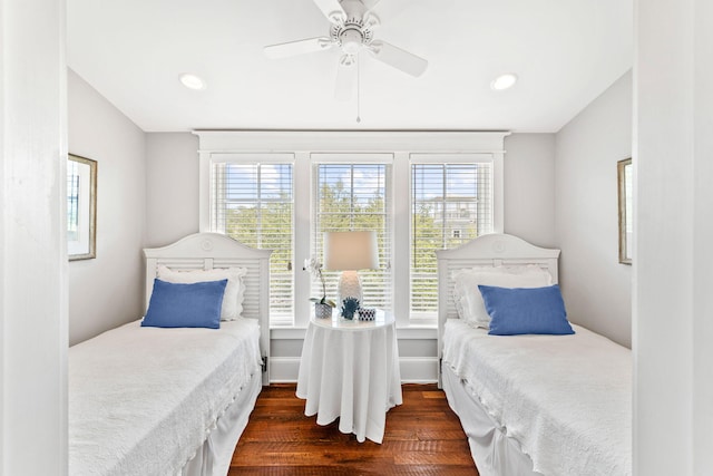 bedroom featuring vaulted ceiling, multiple windows, ceiling fan, and dark hardwood / wood-style floors