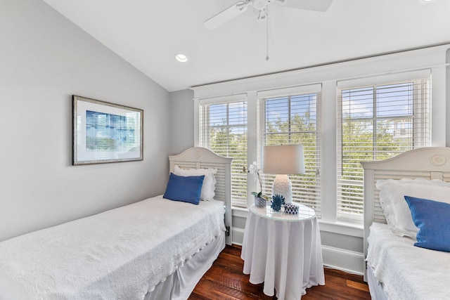 bedroom with ceiling fan, vaulted ceiling, and dark wood-type flooring