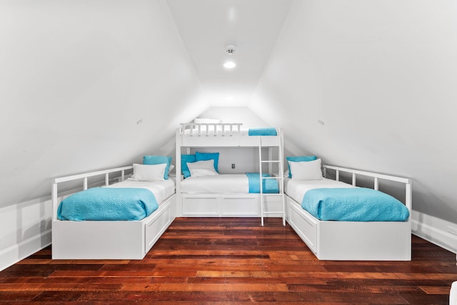 bedroom featuring dark wood-type flooring and vaulted ceiling