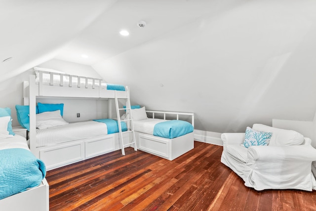 bedroom with dark hardwood / wood-style flooring and lofted ceiling