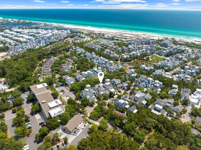 drone / aerial view with a water view and a beach view