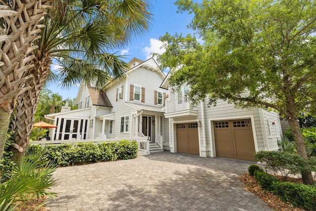 view of front of house featuring a garage and a balcony