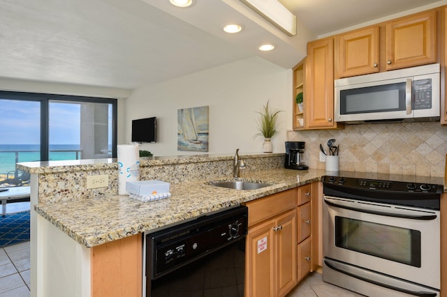 kitchen with sink, stainless steel appliances, light stone counters, kitchen peninsula, and light tile patterned floors