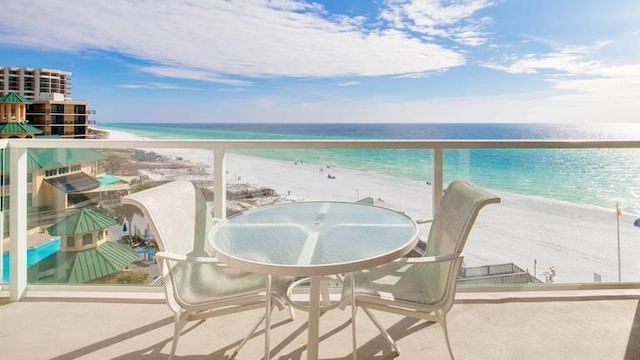 balcony with a beach view and a water view