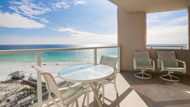 balcony with a view of the beach and a water view