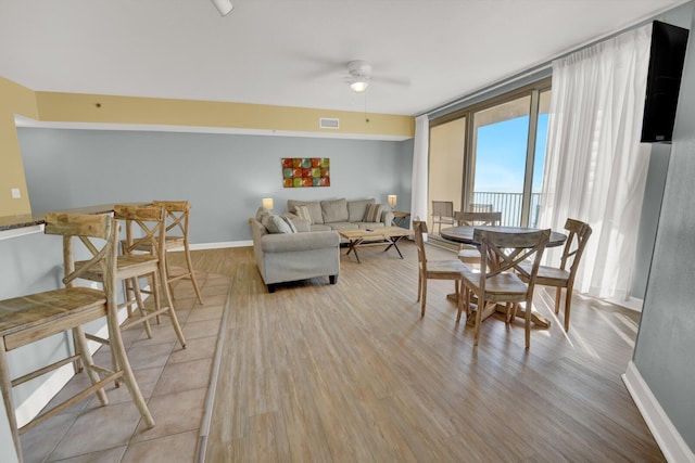 living room featuring hardwood / wood-style floors and ceiling fan