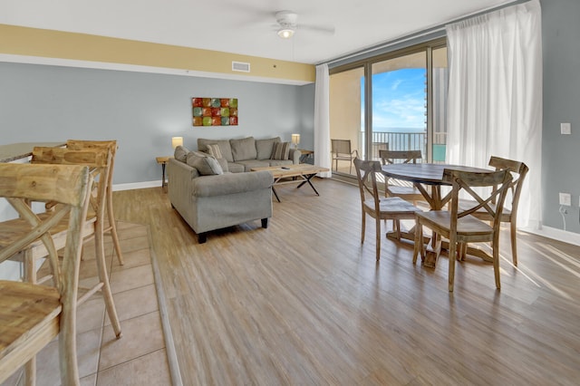 living room with wood-type flooring and ceiling fan