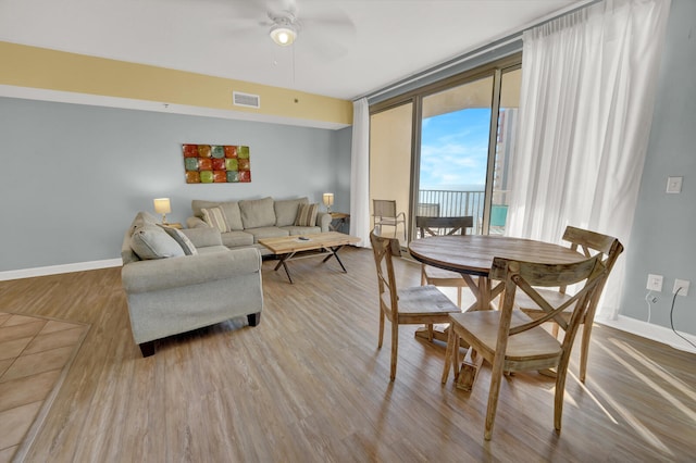 dining space featuring hardwood / wood-style floors and ceiling fan