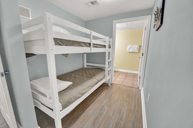 bedroom with hardwood / wood-style flooring