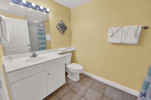 bathroom featuring oversized vanity, tile floors, and toilet