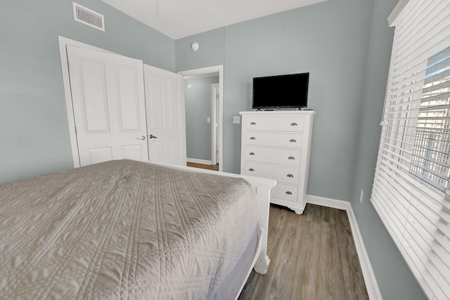 bedroom with hardwood / wood-style floors and a closet