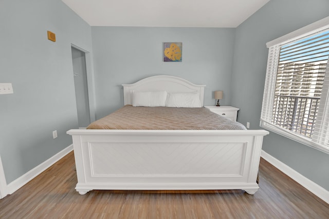 bedroom with dark hardwood / wood-style flooring