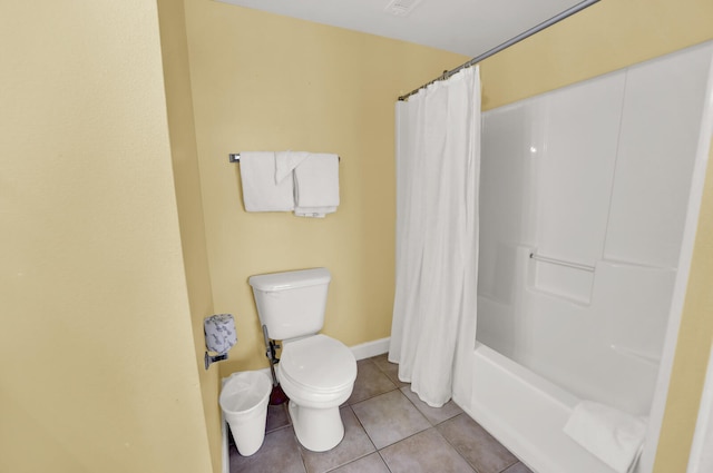 bathroom featuring tile flooring, toilet, and shower / bath combo with shower curtain