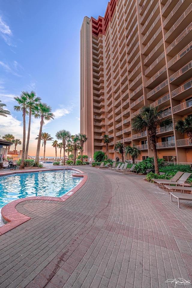 pool at dusk with a patio