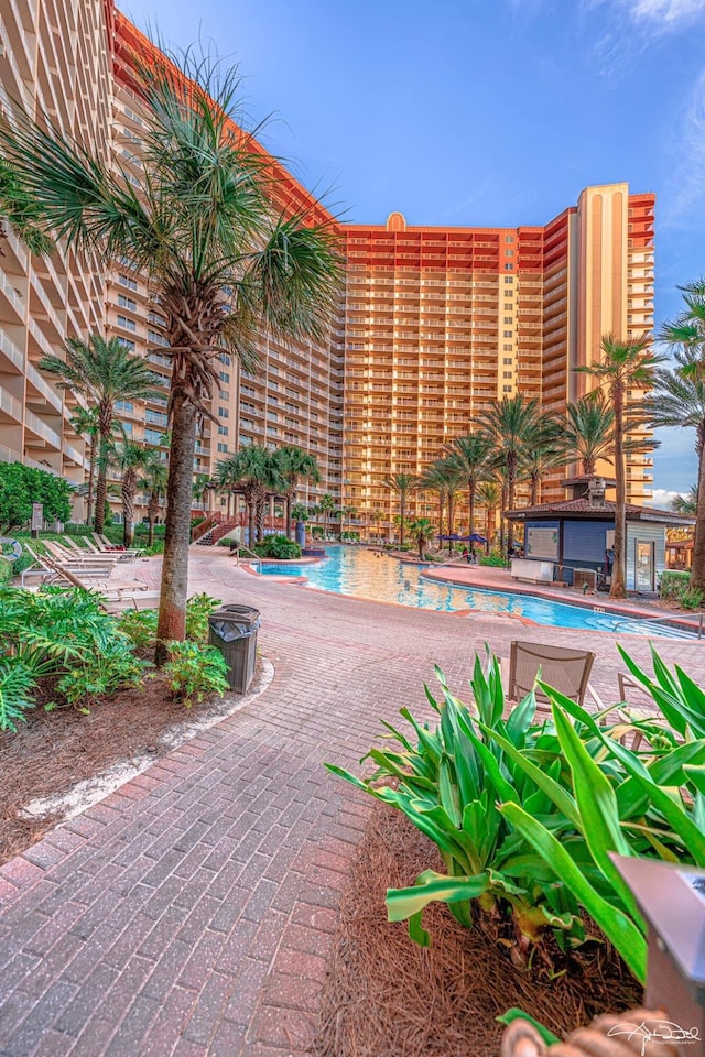 surrounding community featuring a pool and a patio area