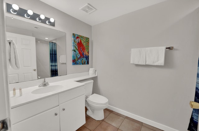 bathroom with oversized vanity, tile floors, and toilet