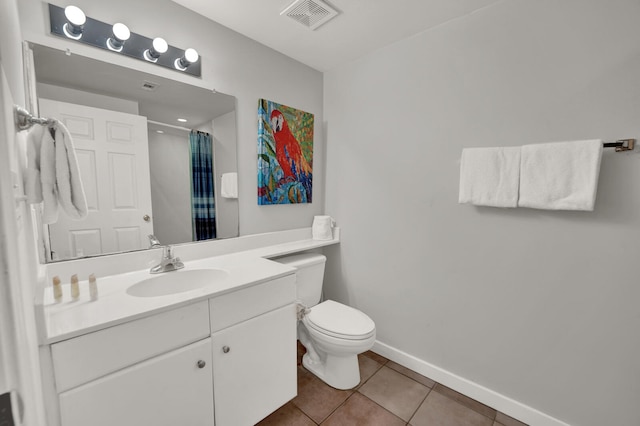 bathroom featuring tile flooring, oversized vanity, and toilet