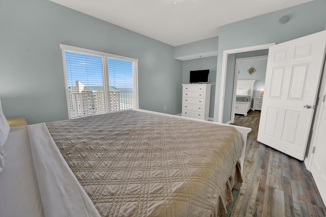 bedroom with dark wood-type flooring