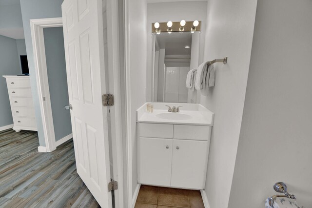 bathroom featuring hardwood / wood-style floors and large vanity