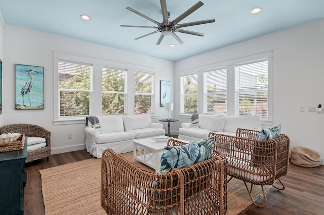 living room featuring ceiling fan and dark hardwood / wood-style floors