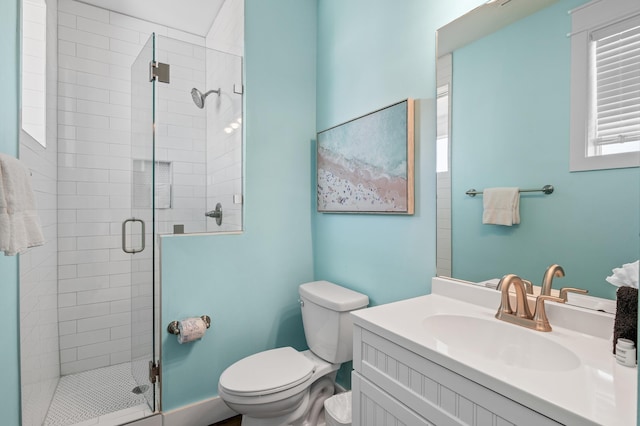 bathroom with walk in shower, vanity, and toilet