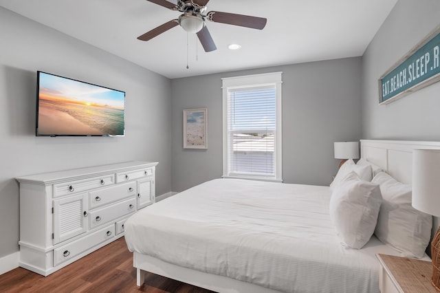 bedroom with dark hardwood / wood-style flooring and ceiling fan