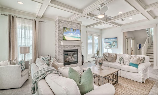 living room with coffered ceiling, ceiling fan, crown molding, beam ceiling, and a fireplace