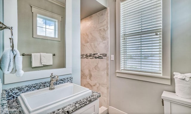 bathroom with a wealth of natural light, sink, and toilet